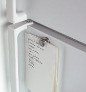 Magnetic Spring Clip holding several sheets of paper on a fridge door