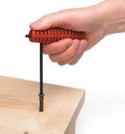 Using a hex key handle on a hex key to install a screw