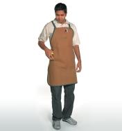 A man wearing a Lee Valley Apron puts a tape measure in the pocket