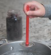 Lifting a lid out of boiling water using the Magnetic Lid Lifter