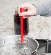 Lifting a lid out of boiling water using the Magnetic Lid Lifter