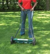 A woman pushes the Lee Valley 20"  Mower over grass