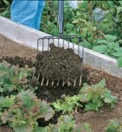 Adding compost to a garden with the Lee Valley Compost & Mulch Fork
