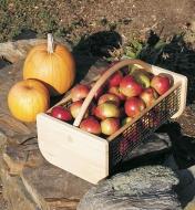 Large Maine garden hod filled with apples sits next to two pumpkins on some rocks