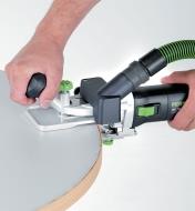 Using the router and horizontal base to trim edging on a curved tabletop