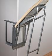 Pull-Out Ironing Board swinging downward to rest on its hinged legs