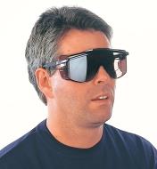 A man wearing tinted safety overglasses