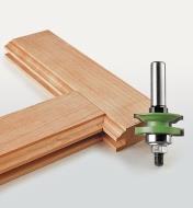 Reversible Ogee Frame Bit next to two boards with rail and stile profiles cut into them