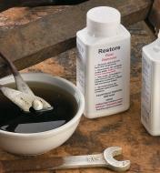 Soaking a wrench in Rust Remover Concentrate