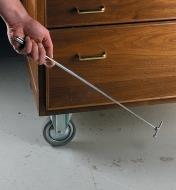 Using the Pocket Magnet/Pin Retriever to pick up a screw off the floor