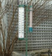 Rain Gauge with Thermometer mounted in a yard