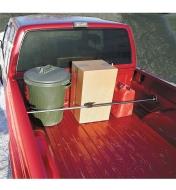Ratcheting Cargo Bar installed in a truck bed, holding cargo in place