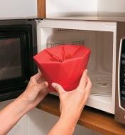Placing the closed Poptop Popcorn Popper in the microwave