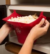 Removing the Poptop Popcorn Popper filled with popped popcorn from the microwave