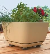 Four pot pads supporting a large planter on a wooden deck
