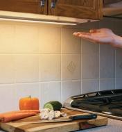 Passing a hand under a Touchless Dimmer Switch to activate LED lighting under kitchen cabinets