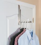 Stainless-Steel Hook & Hanger hung over a door, holding several shirts on clothes hangers