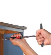 Using the T-Handle Driver to drive a screw in the back of a bookcase