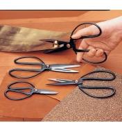 Using Chinese Scissors to cut a brass sheet, with another pair lying on sandpaper