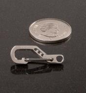 TEC Python Clip next to a quarter for size comparison