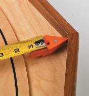 Measuring from an angled corner using a tape measure and tape tip
