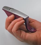 Holding a curved palm plane upside down to show the sole