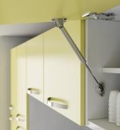 Soft-Open/Close Gas Spring Stay installed in a cabinet, holding an upward-swinging door open