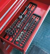The two sizes of socket organizer sets with sockets, and accessory holder installed holding socket wrench, stored in a tool chest.