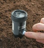 Soil Moisture & pH Meter inserted in soil