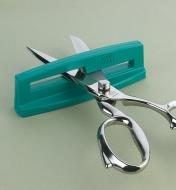 Scissors inserted in sharpener