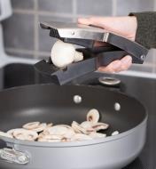 Soft Food Slicer slicing mushrooms into a frying pan