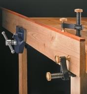 Veritas Surface Clamps securing the end of a long board held in a bench vise