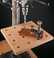 Veritas Surface Clamp holding stock on a drill press table