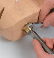Using a wrench to tighten the locking nut