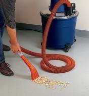 Vacuuming wood chips using the claw tool on the wet/dry vacuum accessory kit
