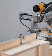 Flip stop in use on a miter saw stand