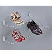 Both sizes of wall-mount shoe racks mounted on a wall, holding three pairs of shoes