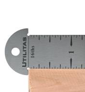 Close-up of hook rule seated on the edge of a board