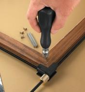 Using the V-Nail and Brad Driver to drive V-nails into the corner of a picture frame