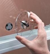 Removing the Window-Mount Thermometer from the adhesive central hub attached to a windowpane