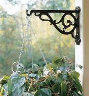 Black Victorian Wall Bracket holding a hanging basket on an outdoor post