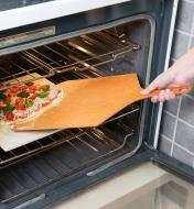 Sliding a pizza into an oven using the Pizza Peel