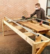 A wood slab is flattened using a router and the assembled router sled