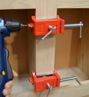 Bessey face-frame cabinet clamps hold a pair of cabinet stiles together as they are fastened