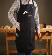 A man wearing a Veritas Apron in a workshop