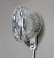 Ghosted image of the oscillating head of the Air King wall-mount fan