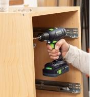 Installing hinges in a cabinet using the Festool T 18+3 Easy cordless drill equipped with the 4.0 Ah battery