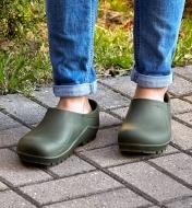 A person wearing European garden clogs