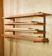 A measuring tape sits on wooden boards stacked on a Bora four-shelf lumber rack