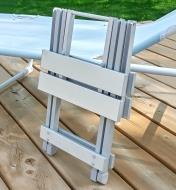 Folded table leaning against a deck chair